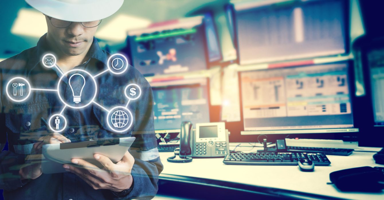 Double exposure of Engineer or Technician man with business industrial tool icons while using tablet with monitor of computers room for oil and gas industrial business concept Double exposure of Engineer or Technician man with business industrial tool icons while using tablet with monitor of computers room for oil and gas industrial business concept