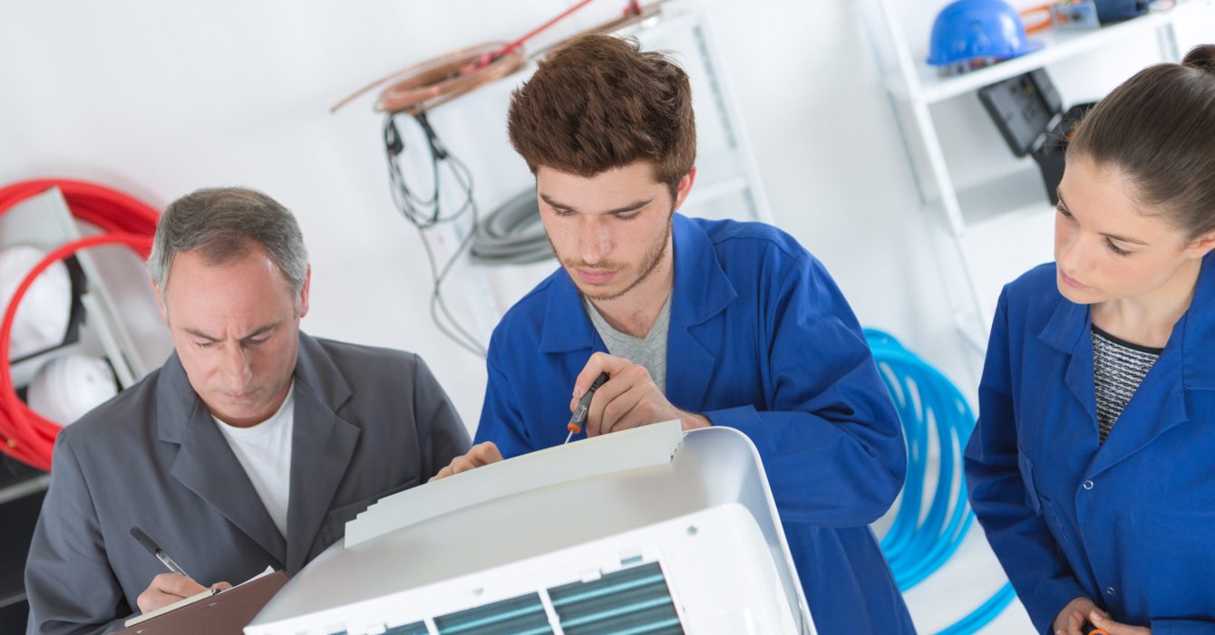 electrician repairman and apprentices fixing air conditioning electrician repairman and apprentices fixing air conditioning