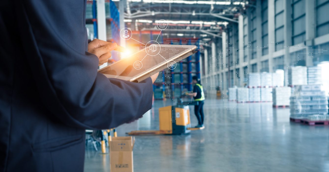 Businessman manager using tablet check and control for workers with Modern Trade warehouse global business commerce concept or import-export commercial logistic. Industry 4.0 concept Businessman manager using tablet check and control for workers with Modern Trade warehouse global business commerce concept or import-export commercial logistic. Industry 4.0 concept