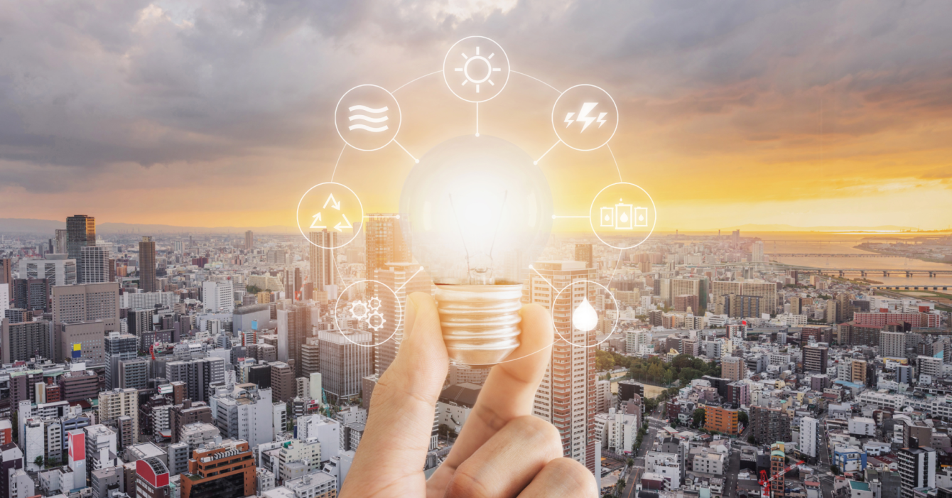 ESG: The Risks & Rewards for Real Estate Portfolio Owners An image of a lightbulb surrounding buildings